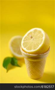 Cut lemon fruit in ice cream cone with lemon slices