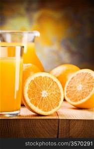 cut oranges and juice in glass