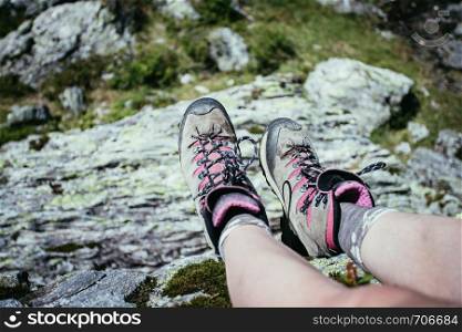 Cut out of a woman in hiking boots who is enjoying the idyllic mountain landscape