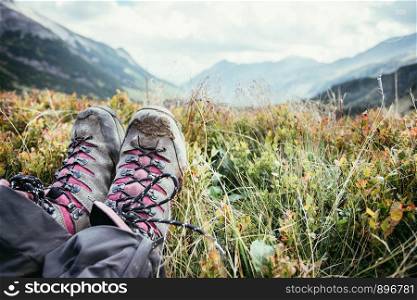 Cut out of a woman in hiking boots who is enjoying the idyllic mountain landscape
