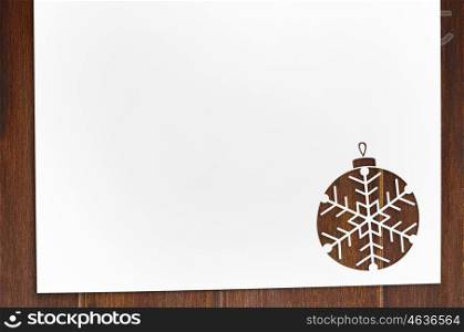 cut paper in ball shape on table. Cut paper in decorative ball shape for christmas card or new year background on wooden table
