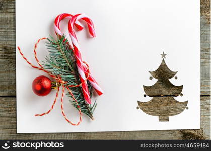 cut paper in fir-tree shape on table. Cut paper in fir-tree shape with decoration for christmas card or new year background on wooden table