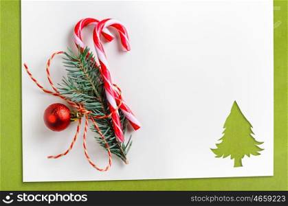 cut paper in fir-tree shape on table. Cut paper in fir-tree shape with decoration for christmas card or new year background on green table
