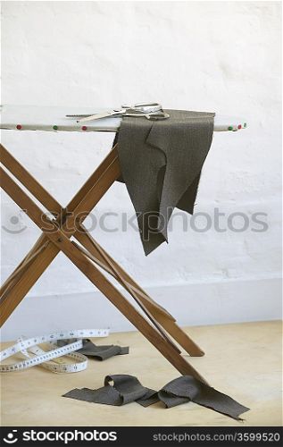 Cut pieces of fabric on ironing board