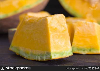 cut pieces of pumpkin orange during cooking for dinner from vegetables, close-up. cut pieces of pumpkin