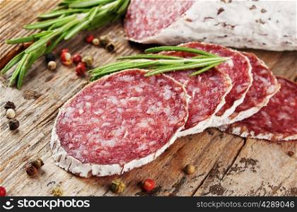 Cut pieces of smoked salami with rosemary