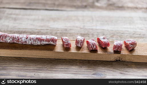 Cut spanish salami on the wooden board