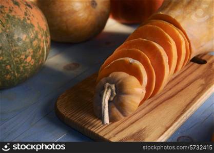 cut the pumpkin into pieces on blue wooden background