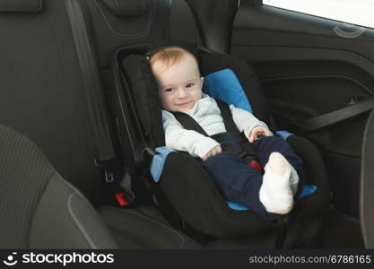 Cute 6 months old baby in car child seat