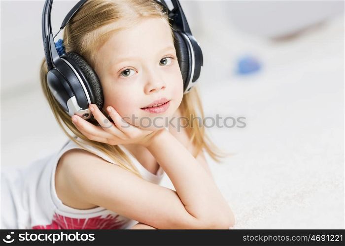 Cute adorable girl wearing headphones and enjoying music. I like listen music