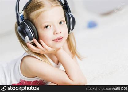 Cute adorable girl wearing headphones and enjoying music. I like listen music