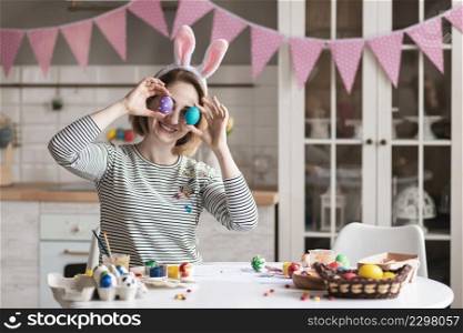 cute adult woman playing with easter eggs