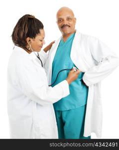 Cute african-american doctors. She&rsquo;s pretending to give him a checkup. Isolated on white.