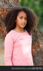 Cute African American girl in the street with afro hair. Cute African American girl smiling in the street with afro hair