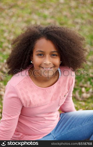 Cute African American girl in the street with afro hair. Cute African American girl smiling in the street with afro hair