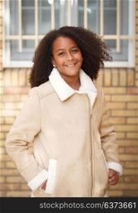 Cute African American girl smiling in the street with afro hair