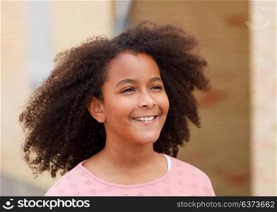 Cute African American girl smiling in the street with afro hair