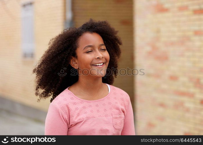 Cute African American girl smiling in the street with afro hair