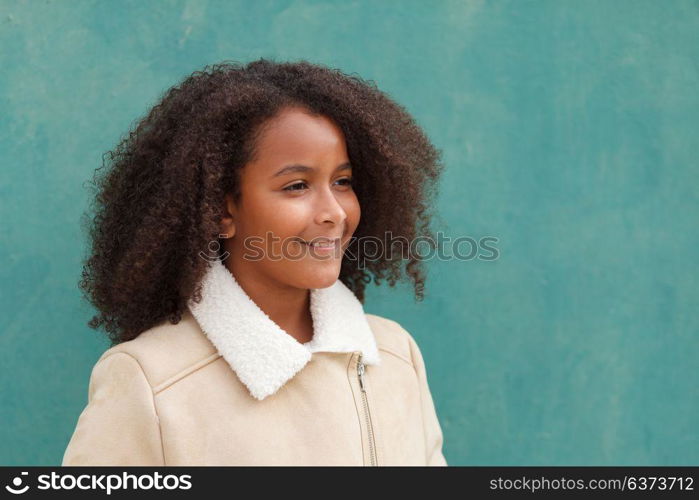 Cute African American girl smiling with afro hair on a green background