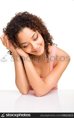 Cute afro girl thinking on a table over white background