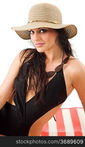 cute and attractive brunette wearing a summer hat and black swimsuit sitting