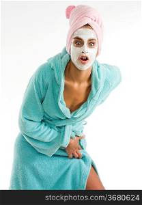 cute and nice girl with face cream mask looking in camera with surprise