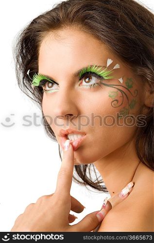 cute and sensual brunette with a finger against the lip and green artificial eyelashes