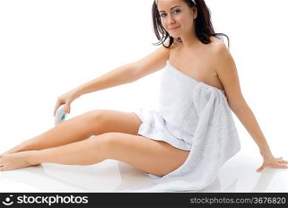 cute and young brunette dressing white towel shaving her legs