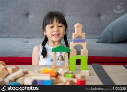 Cute Asian little girl playing with colorful toy blocks, Kids play with educational toys at kindergarten or daycare. The creative playing of the kid development concept, Toddler kid in the nursery.