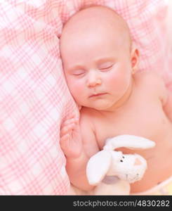 Cute baby asleep in pink bedroom, relaxing in the bed, adorable healthy child dreaming, safe childhood concept
