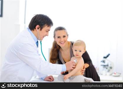 Cute baby being checked by a doctor using a stethoscope &#xA;