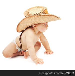 Cute baby boy crawling in the studio, naked child wearing diaper and big cowboy hat, isolated on white background, happy childhood