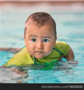 Cute baby boy in a swimming pool