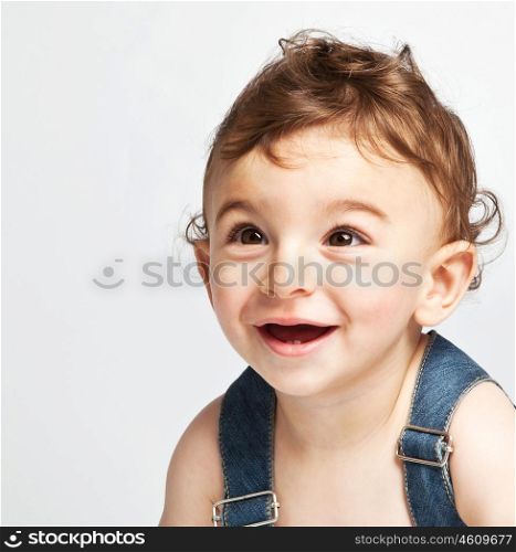 Cute baby boy isolated on white background, portrait of adorable sweet child, cheerful nice kid laughing indoor, pretty curious infant looking ahead, healthy lifestyle, happy childhood concept