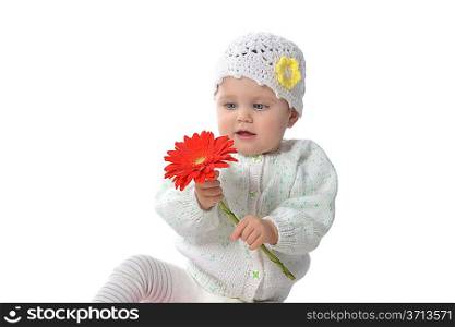 Cute baby girl playing with red flower