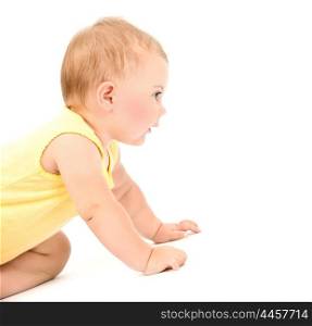 Cute baby girl wearing yellow dress isolated on white background, crawling in the studio, healthy lifestyle, happy childhood concept