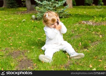 Cute baby girl with new mobile phone