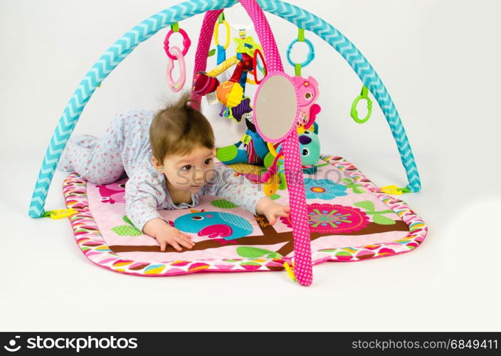 cute baby girld playing in an activity gym