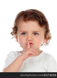 Cute baby has put forefinger to lips as sign of silence, isolated on a white background