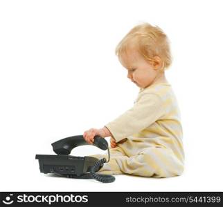Cute baby playing with phone on white background