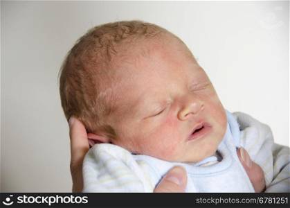 Cute baby sleeping in the hands of its mother. Cute baby sleeping in the hands of its mother with open mouth