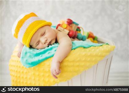 Cute baby sleeping in the wicker basket