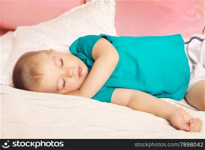 cute baby sleeps on bed at home