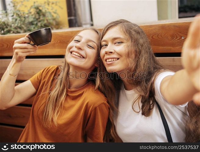 cute best friends taking selfie together
