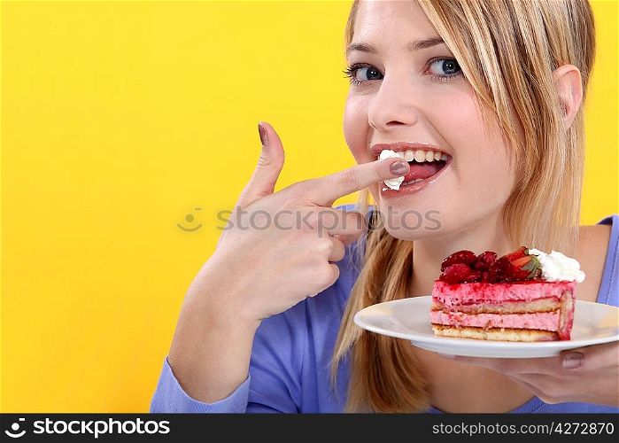 Cute blond eating a cake.