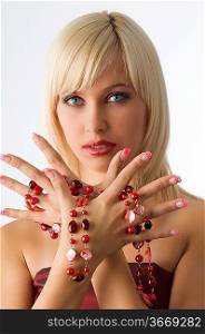 cute blond girl with glamour make up with red necklace around hands
