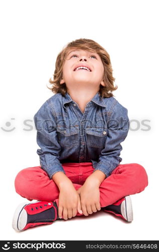 Cute blonde boy posing over white background