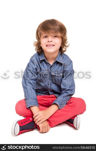 Cute blonde boy posing over white background