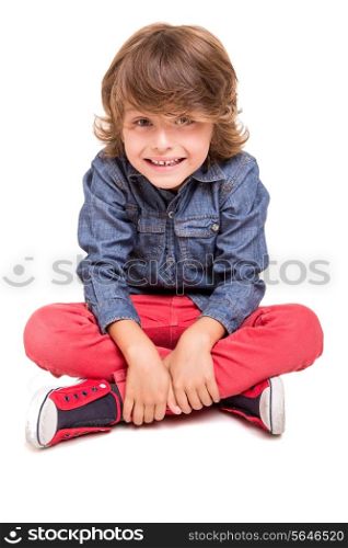Cute blonde boy posing over white background