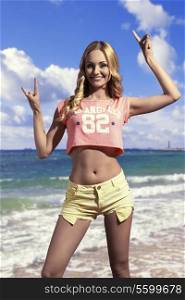 cute blonde lady posing with happy expression and wearing american top and sexy shorts, long wavy hair.